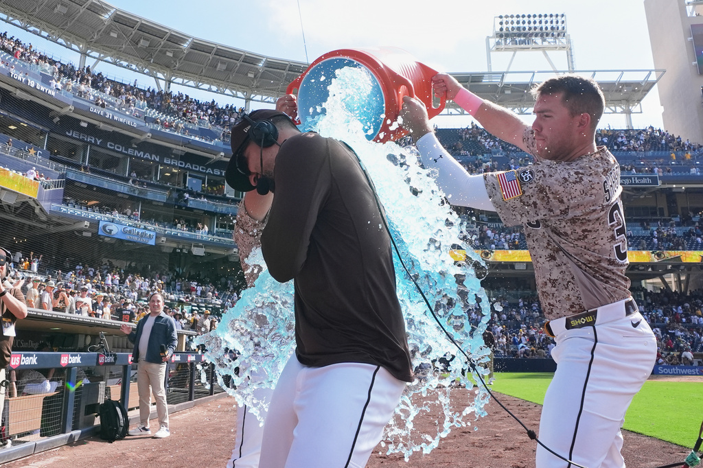 San Diego Padres' Nick Castellanos, center, is doused by teammate Gavin Sheets after the Padres defeated the St. Louis Cardinals 3-2 in a baseball game Sunday, May 10, 2026, in San Diego. (AP Photo/Gregory Bull)