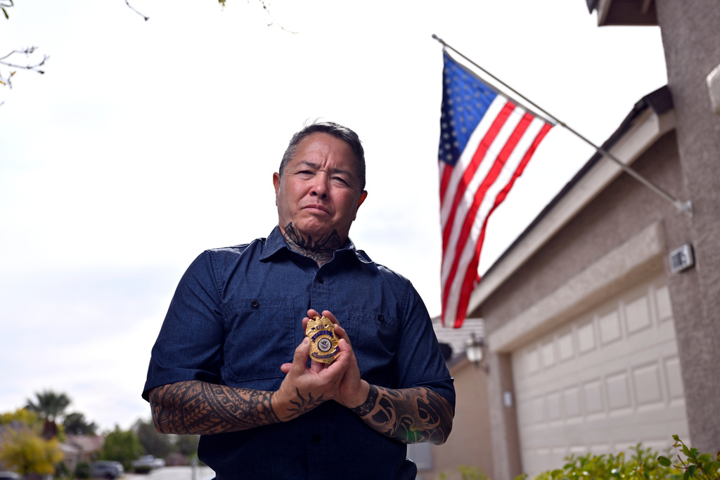 Kai Regan, a former Transportation Security Administration agent, displays his retired TSA badge on Tuesday, Nov. 11, 2025, in Las Vegas. (AP Photo/David Becker)