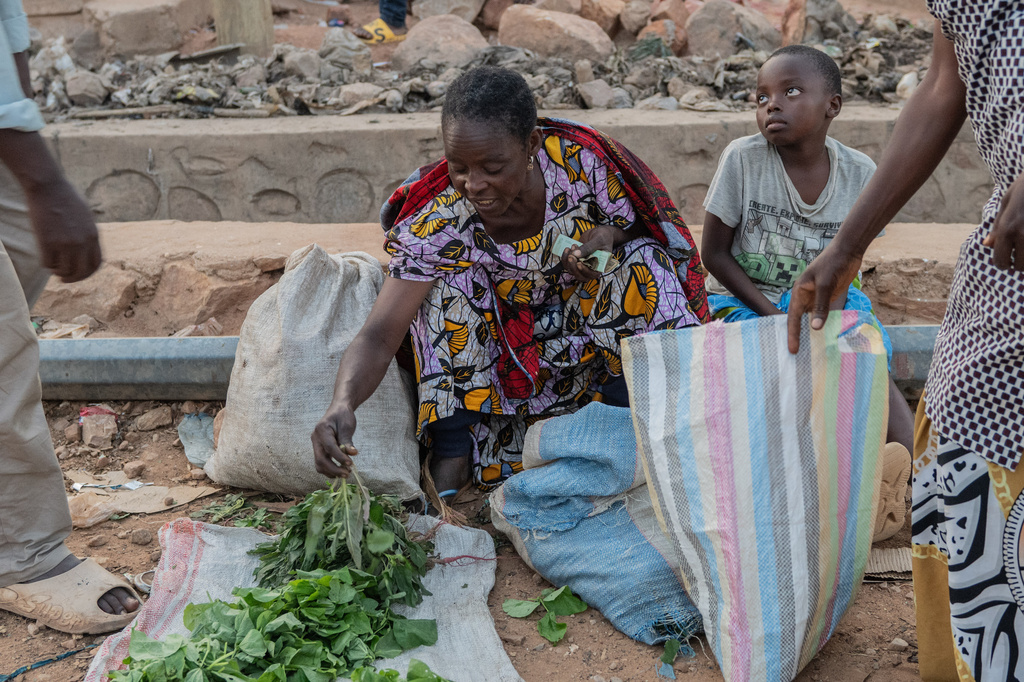 People buy and sell as residents return to their homes in Uvira, Democratic Republic of Congo, Saturday, Dec. 13, 2025. (AP Photo/Moses Sawasawa)