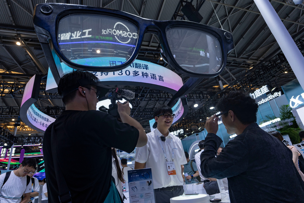 Visitors try out a smart glasses as the World AI Conference in Shanghai, Friday, July 17, 2026. (AP Photo/Ng Han Guan)