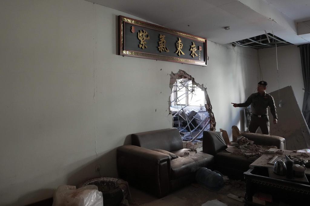 A Thai policeman inspects a scam compound in O'Smach, Cambodia, Monday, Feb. 2, 2026, (AP Photo/Sakchai Lalit)