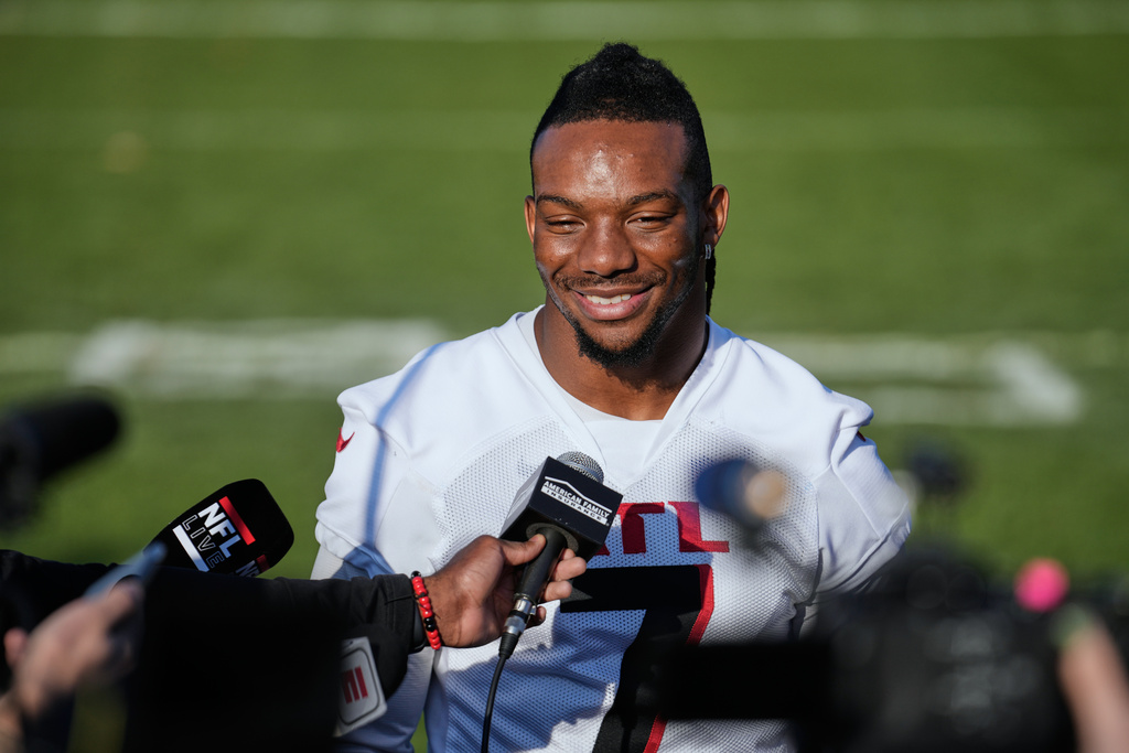 Atlanta Falcons running back Bijan Robinson (7) speaks with media after a tarining session during an NFL football training camp practice, in Berlin, Germany, Friday, Nov. 7, 2025. (AP Photo/Ebrahim Noroozi)