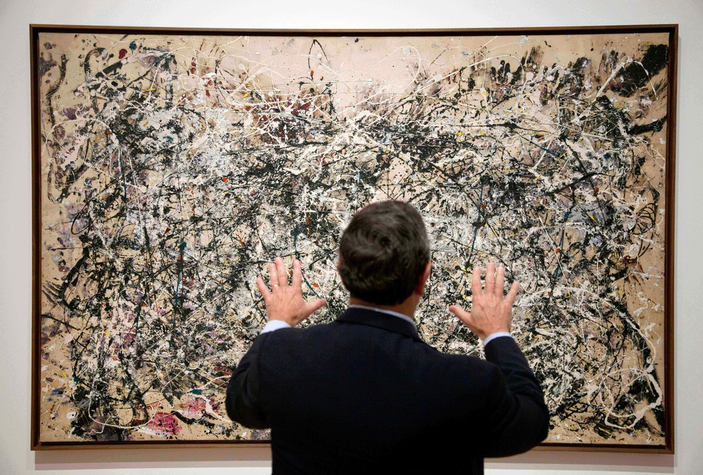FILE - David Brenneman, director of collections and exhibitions at the High Museum, talks about Jackson Pollock's painting "Number 1A" on display as part of an exhibit in Atlanta on Oct. 6, 2011. (AP Photo/David Goldman, File)