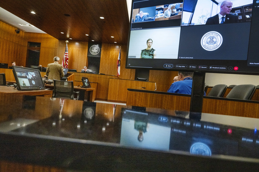 Defense attorney Greg Skordas, left, speaks before judge Tony Graf, back center left, as Tyler Robinson, accused of fatally shooting Charlie Kirk, attends a virtual court hearing from prison on Tuesday, Sept. 16, 2025, in Provo, Utah. (Scott G Winterton/The Deseret News via AP, Pool)