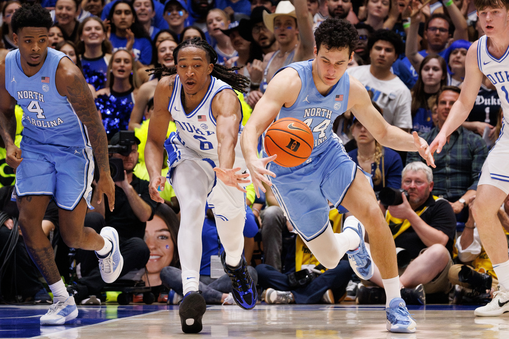 Duke's Maliq Brown (6) and North Carolina's Luka Bogavac (44) chase a loose ball during the first half of an NCAA college basketball game in Durham, N.C., Saturday, March 7, 2026. (AP Photo/Ben McKeown)