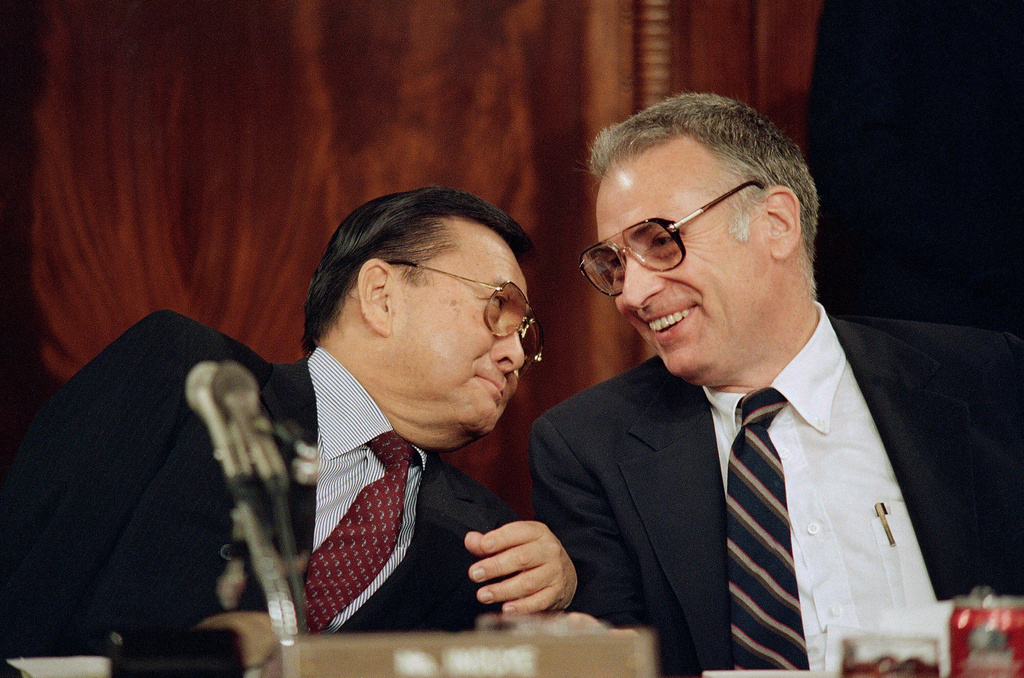 FILE - Sen. Daniel Inouye, D-Hawaii, left, and Rep. Lee Hamilton, D-Ind., chairmen of the Senate and House select committees on the Iran-Contra affair, confer as the group continued hearings on Capitol Hill, in Washington, May 8, 1987. (AP Photo/Lana Harris, File)