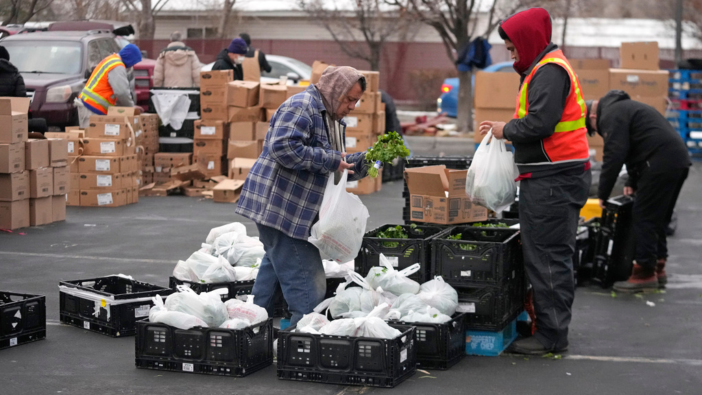 FILE - Utah Food Bank volunteers gather groceries for the needy at a mobile food pantry distribution site Dec. 21, 2022, in Salt Lake City. (AP Photo/Rick Bowmer, File)