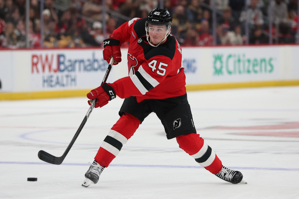 New Jersey Devils defenseman Colton White (45) passes the puck during the second period of an NHL hockey game against the Pittsburgh Penguins, Saturday, Nov. 8, 2025, in Newark, N.J. (AP Photo/Heather Khalifa)