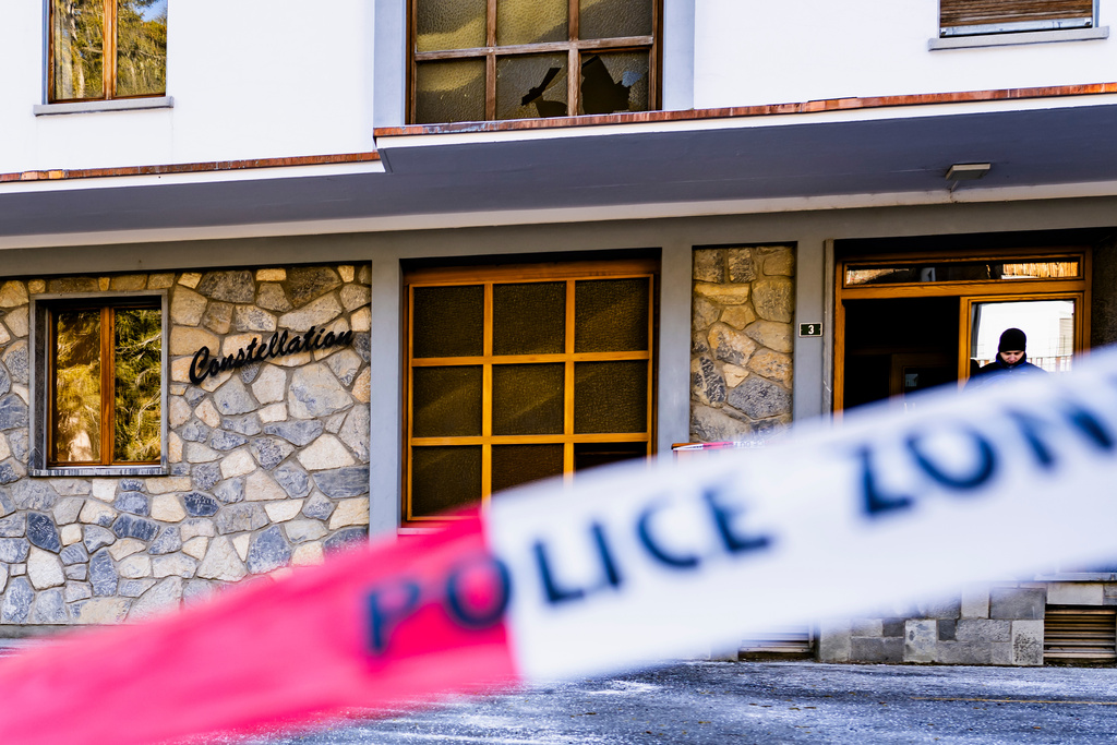 Police officers inspect the area where a fire broke out at the Le Constellation bar and lounge leaving people dead and injured, during New Year’s celebration, in Crans-Montana, Swiss Alps, Switzerland, Thursday, Jan. 1, 2026. (Jean-Christophe Bott/Keystone via AP)