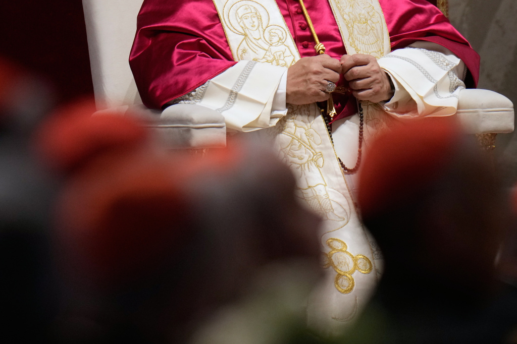 Pope Leo XIV holds a rosary as he leads a vigil for peace inside St. Peter's Basilica at the Vatican, Saturday, April 11, 2026. (AP Photo/Gregorio Borgia)