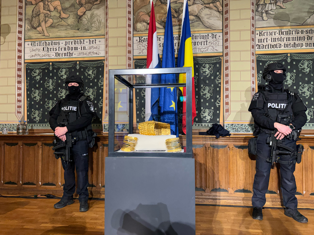 Police officers stand by a stolen artefact from Romania, the 2,500-year-old Cotofenesti helmet, recovered in Netherlands, is shown during a press conference in Assen, Netherlands, Thursday, April 2, 2026. (AP Photo/Aleksandar Furtula)
