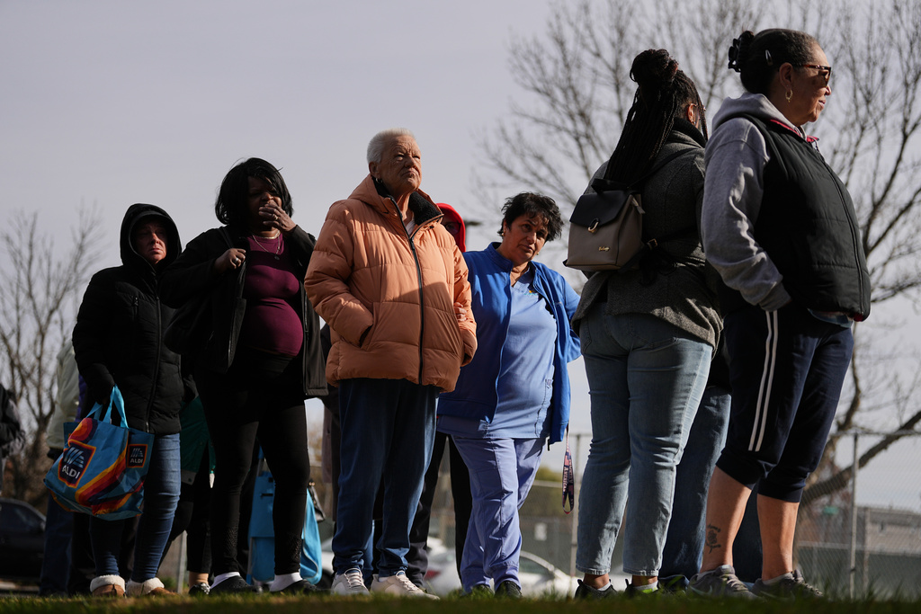 Fran Cooper, center left,, accompanied by her care giver Lily Bubjaku, waits in line durning an emergency food distribution at The Jewish Federation of Greater Philadelphia's Mitzvah Food Program in Philadelphia, Friday, Nov. 7, 2025. (AP Photo/Matt Rourke)