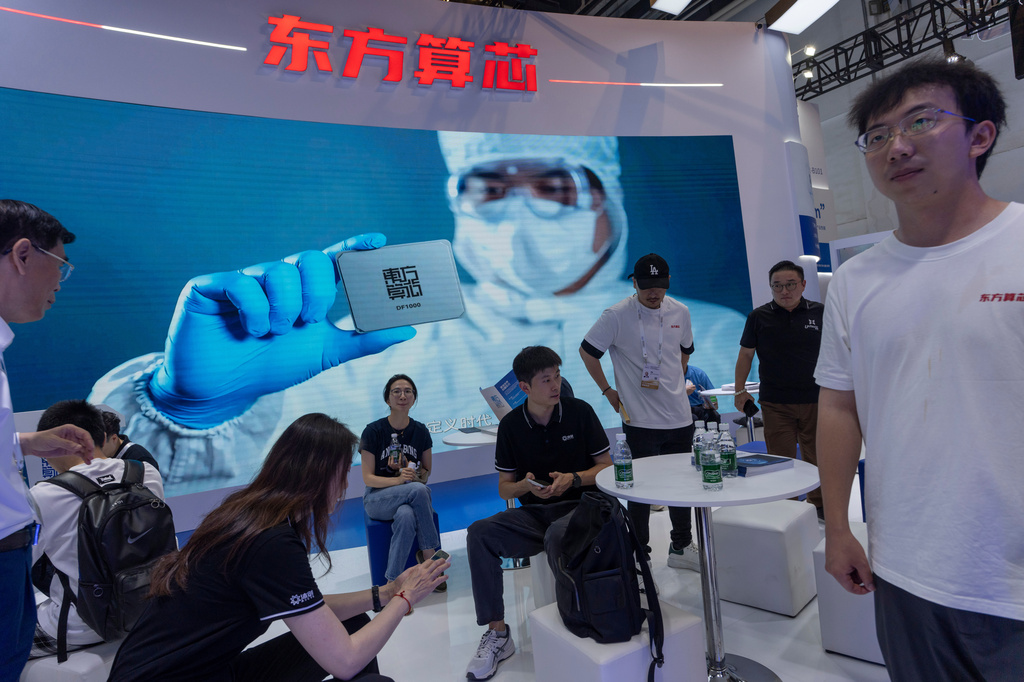 People visit the booth for Chinese AI-computing chip start up Dongfang Suanxin during the World AI Conference in Shanghai, July 17, 2026. (AP Photo/Ng Han Guan)
