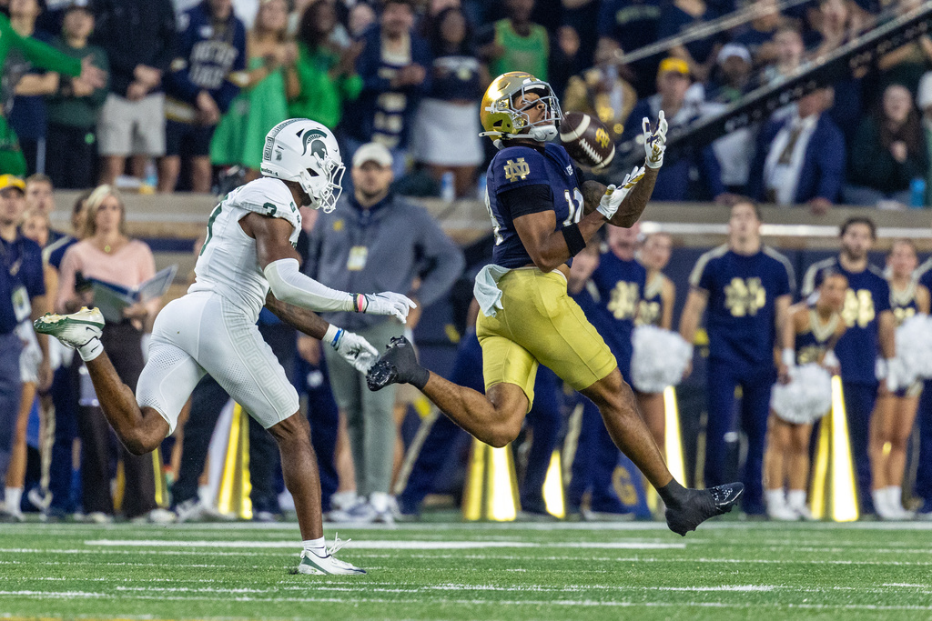 Notre Dame wide receiver Micah Gilbert (14) catches a 61 yard pass from quarterback CJ Carr (13) during the first half of a college football game against Michigan State, Saturday, Sept. 19, 2026, in South Bend, Ind. (AP Photo/Paul Barnick)