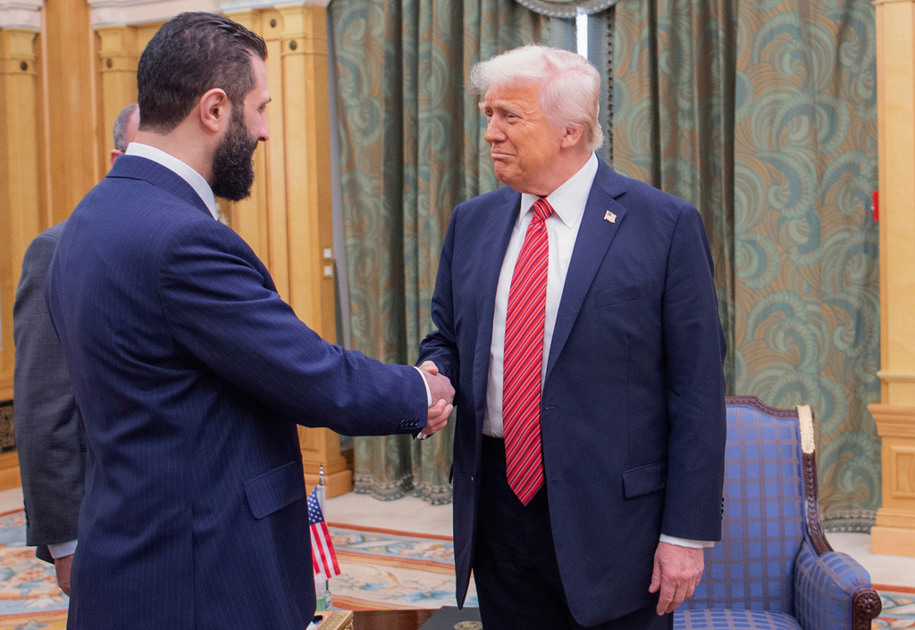 FILE - In this photo released by the Saudi Royal Palace, President Donald Trump, right, shakes hands with Syria's interim President Ahmad al-Sharaa in Riyadh, Saudi Arabia, May 14, 2025. (Bandar Aljaloud/Saudi Royal Palace via AP, File)