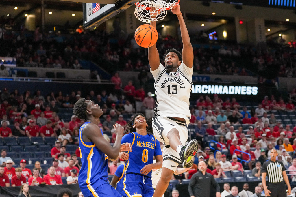 Vanderbilt center Jalen Washington, right, dunks over McNeese guard Tyshawn Archie, middle and forward Peitok Machar, left, during the first half in the first round of the NCAA college basketball tournament, Thursday, March 19, 2026, in Oklahoma City. (AP Photo/Kyle Phillips)