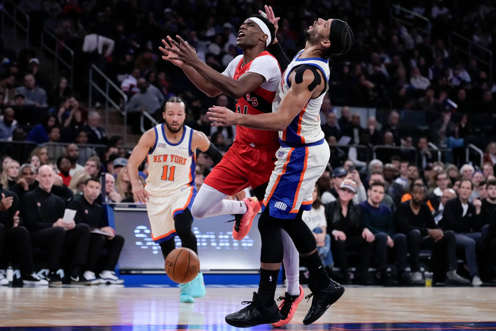 Toronto Raptors guard Ja'Kobe Walter (14) fails to drive past New York Knicks guard Josh Hart (3) during the first half of an NBA basketball game Sunday, Nov. 30, 2025, in New York. (AP Photo/Yuki Iwamura)