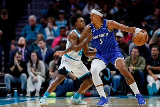 Orlando Magic forward Paolo Banchero (5) drives into Charlotte Hornets guard Collin Sexton, left, during the first half of an NBA basketball game in Charlotte, N.C., Thursday, Oct. 30, 2025. (AP Photo/Nell Redmond) Orlando Magic forward Paolo Banchero (5) drives into Charlotte Hornets guard Collin Sexton, left, during the first half of an NBA basketball game in Charlotte, N.C., Thursday, Oct. 30, 2025. (AP Photo/Nell Redmond)