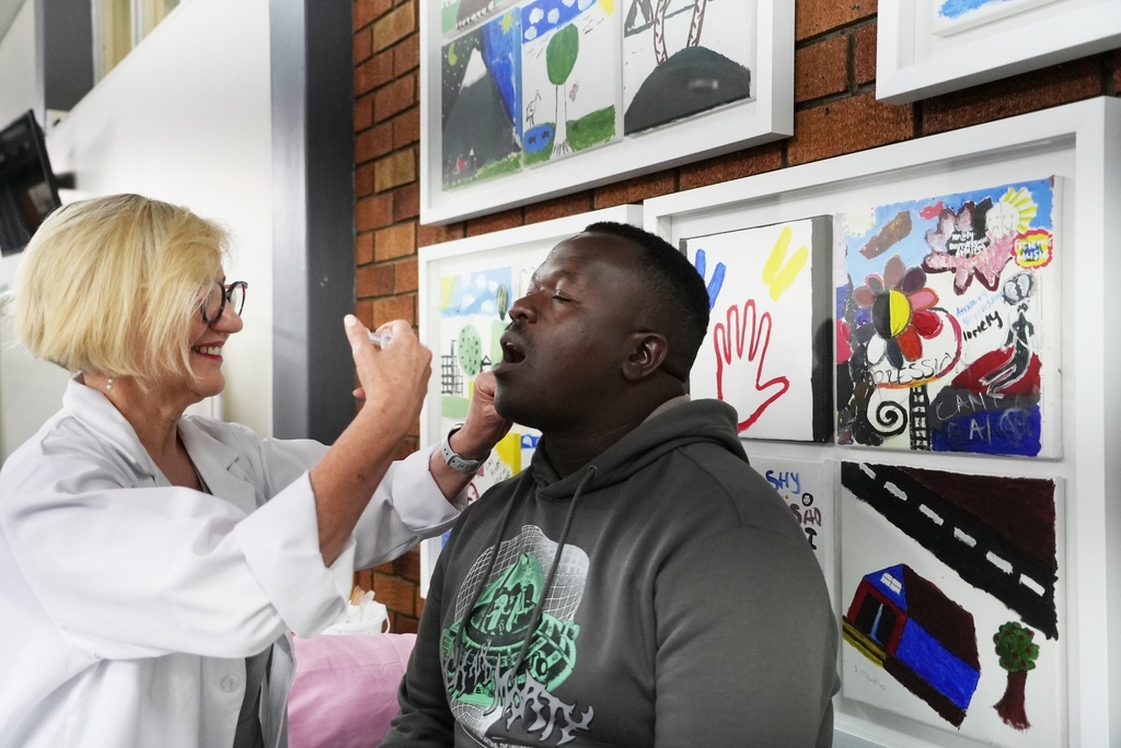 South African Medical Research Council head Prof Glenda Grey administers a cholera vaccine to Shadrack Makutu, a participant in the clinical trials for the vaccine developed by Biovac at the Chris Hani Baragwanath Hospital in Soweto, South Africa, Tuesday, Nov. 11, 2025. (AP Photo/ Alfonso Nqunjana)