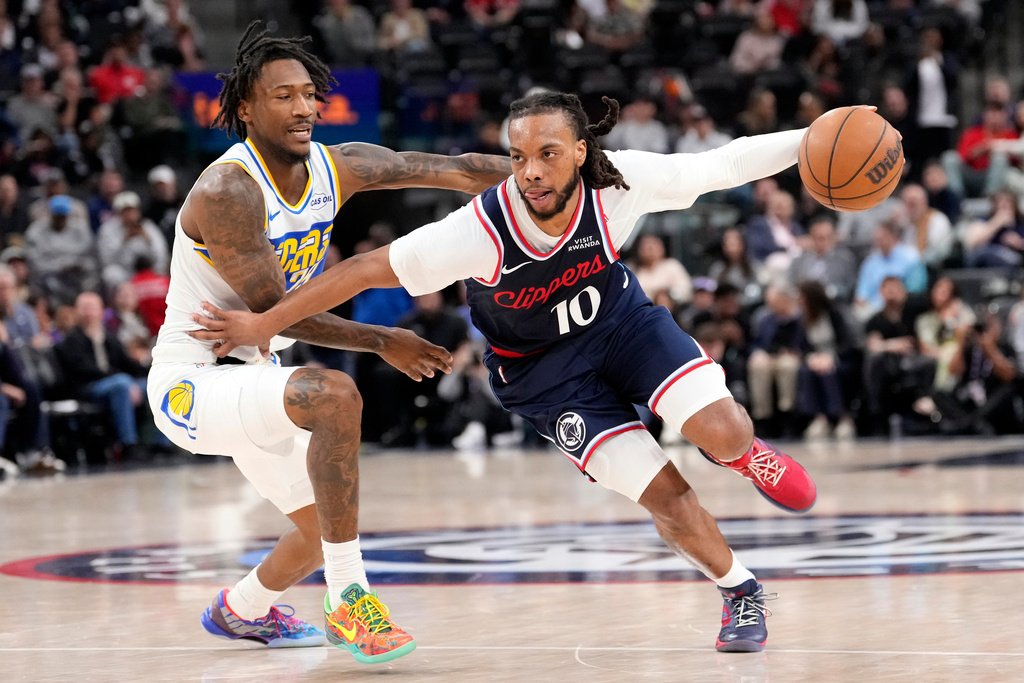 Los Angeles Clippers guard Darius Garland, right, drive past Indiana Pacers guard Quenton Jackson during the second half of an NBA basketball game Wednesday, March 4, 2026, in Inglewood, Calif. (AP Photo/Mark J. Terrill)