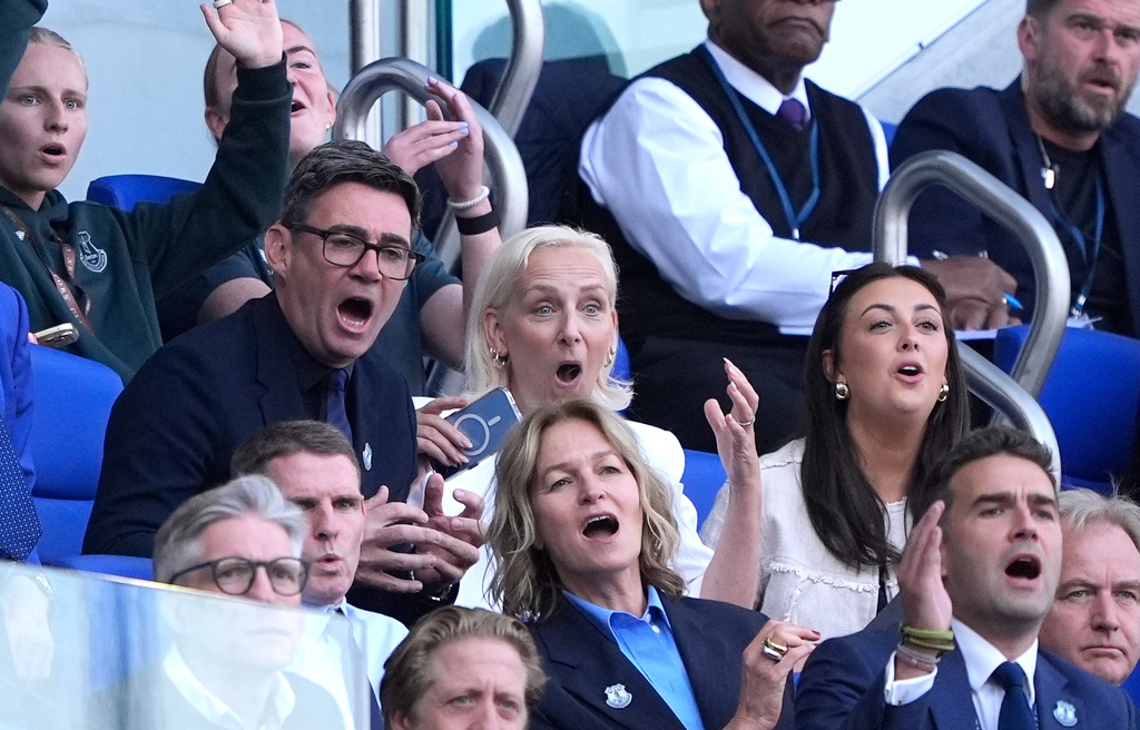 Center row from left, Britain's Prime Minister Andy Burnham, his wife Marie-France van Heel and daughter Rosie attend the English Premier League soccer match between FC Everton and Crystal Palace in Liverpool, England, Saturday, Aug. 22, 2026. (Peter Byrne/PA via AP)