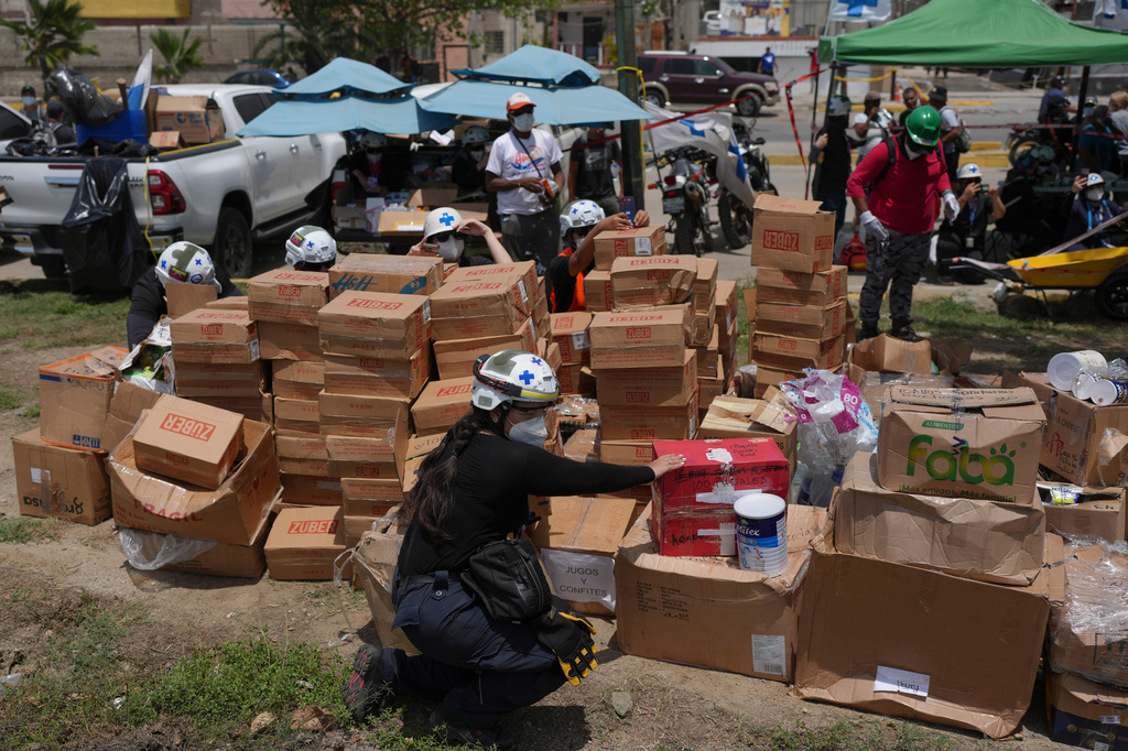 Rescue workers sort humanitarian aid for earthquake survivors in La Guaira, Venezuela, Thursday, July 2, 2026. (AP Photo/Matias Delacroix)