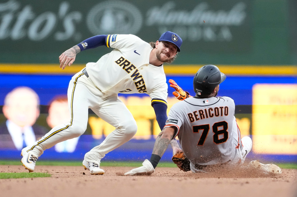 Milwaukee Brewers' Brice Turang (2) tags out San Francisco Giants' Victor Bericoto (78) at second base during the seventh inning of a baseball game Wednesday, June 3, 2026, in Milwaukee. (AP Photo/Aaron Gash)