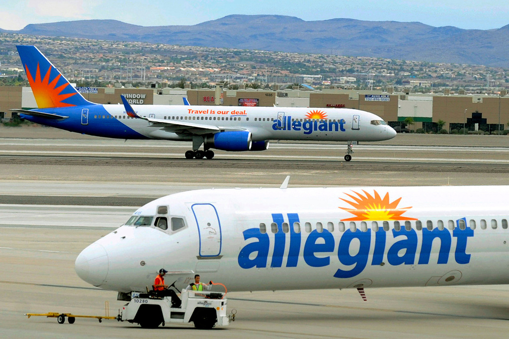 File - In this May 9, 2013, file photo, two Allegiant Air jets taxi at McCarran International Airport in Las Vegas. (AP Photo/David Becker, File)