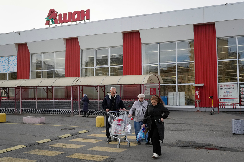 FILE - Customers walk after shopping in a store of the French retailer Auchan in St. Petersburg, Russia, Thursday, Oct. 24, 2024. (AP Photo/Dmitri Lovetsky, file)