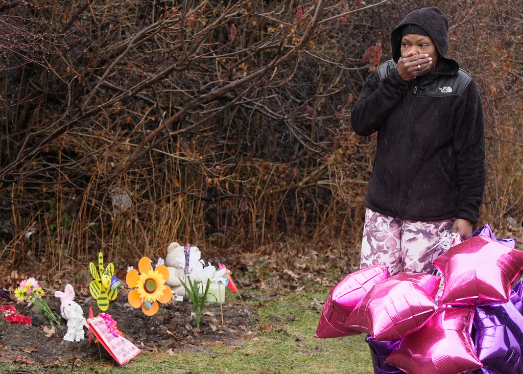 Nichelle Wilson, the grandmother of one of the girls whose bodies were found earlier this week, Amor Wilson, holds her hand to her face as she arrives at the memorials at that site, in Cleveland, Thursday, March 5, 2026. (AP Photo/Sue Ogrocki)