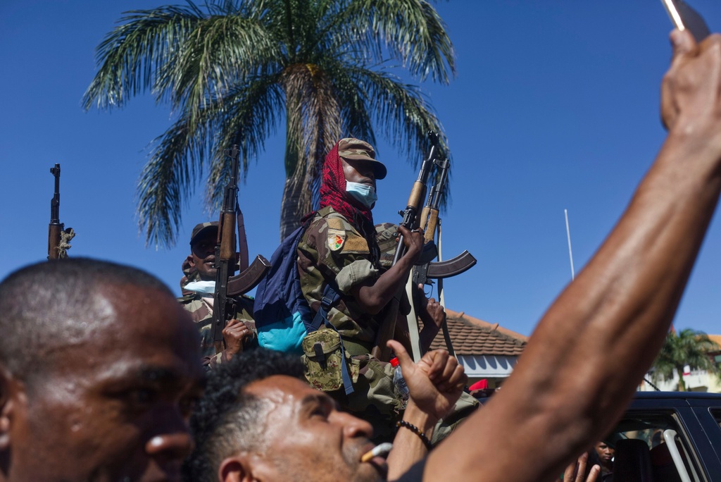 People taking selfies as the soldiers joined anti-government protests in the city center in Antananarivo, Madagascar, Sunday, Oct. 12, 2025. (AP Photo/Alexander Joe)