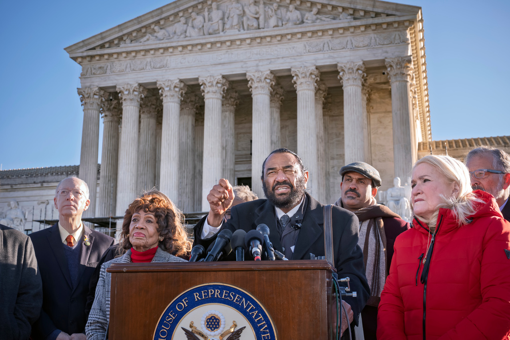 Rep. Al Green, D-Texas, ranking member of the House Subcommittee on Oversight and Investigations, joins Rep. Maxine Waters, D-Calif., ranking member of the House Financial Services Committee, left, as she leads a group of House Democrats to the Supreme Court in support of Federal Reserve Board Governor Lisa Cook ahead of oral arguments about the Trump Administration's attempt to remove from her position, on Capitol Hill in Washington, Wednesday, Jan. 21, 2026. (AP Photo/J. Scott Applewhite)