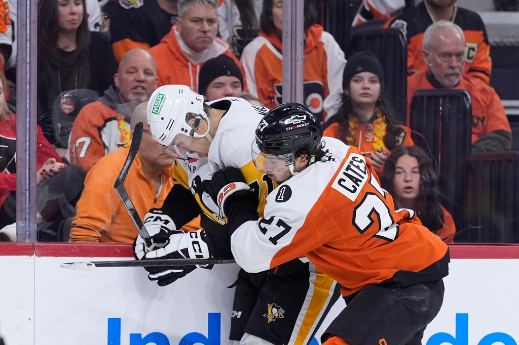 Pittsburgh Penguins' Evgeni Malkin, left, and Philadelphia Flyers' Noah Cates, right, collide during the first period of Game 4 in the first round of the NHL Stanley Cup hockey playoff series Saturday, April 25, 2026, in Philadelphia. (AP Photo/Matt Slocum)