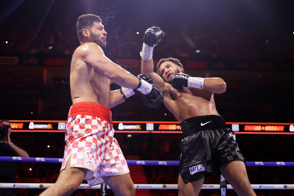 Boxer Moses Itauma, right, punches Filip Hrgovic during their vacant IBF world heavyweight title, Saturday, Aug. 29, 2026, in London. (Steven Paston/PA via AP)