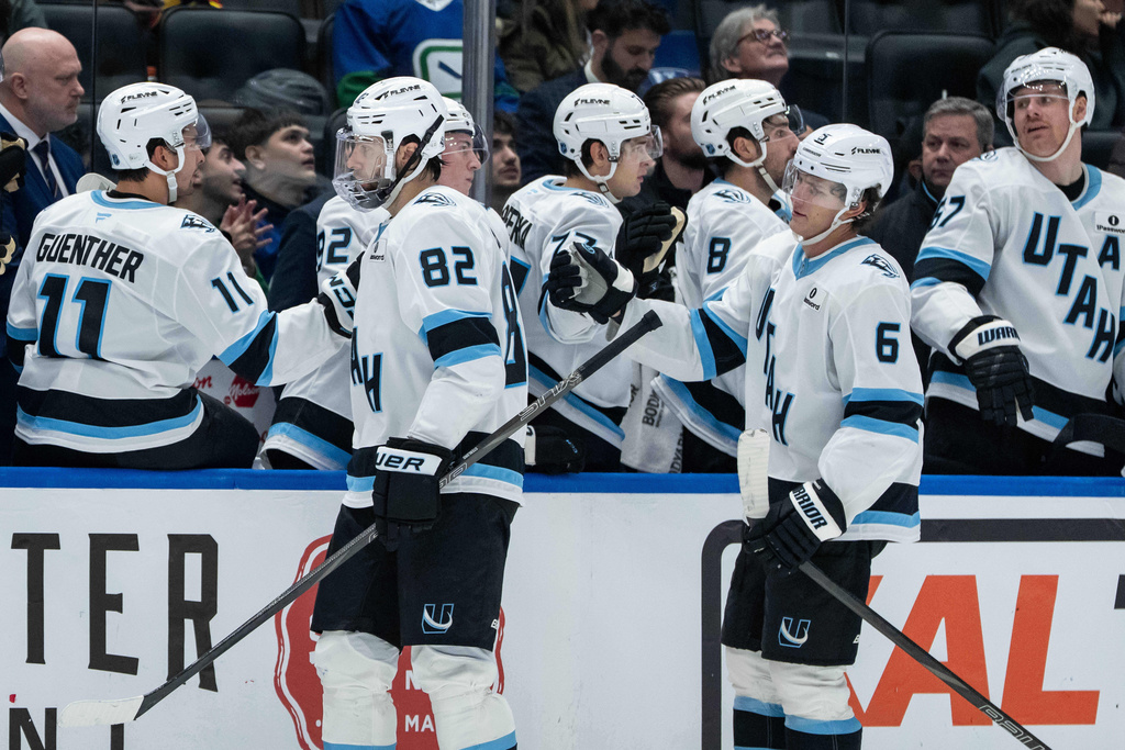 Utah Mammoth's Kevin Stenlund (82) celebrates with teammates after his goal against the Vancouver Canucks during the third period of an NHL hockey game in Vancouver, British Columbia, Friday, Dec. 5, 2025. (Ethan Cairns/The Canadian Press via AP)