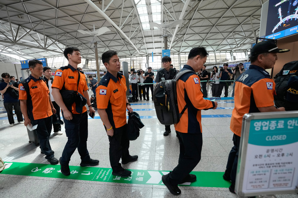 South Korea's Rapid Response Team members prepare to board a plane to Nepal to support search and rescue efforts as South Koreans remain unaccounted for following a massive flooding in Nepal, at the Incheon International Airport in Incheon, South Korea, Thursday, Aug. 27, 2026. (AP Photo/Ahn Young-joon)