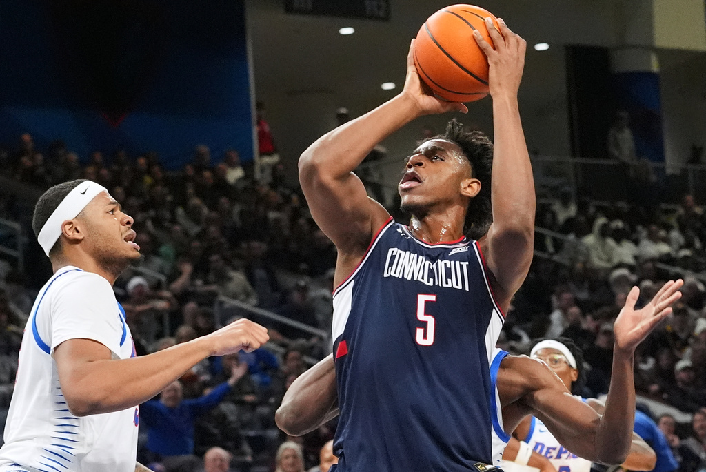 UConn center Tarris Reed Jr., right, shoots against DePaul forward Nj Benson during the first half of an NCAA college basketball game in Chicago, Sunday, Dec. 21, 2025. (AP Photo/Nam Y. Huh)