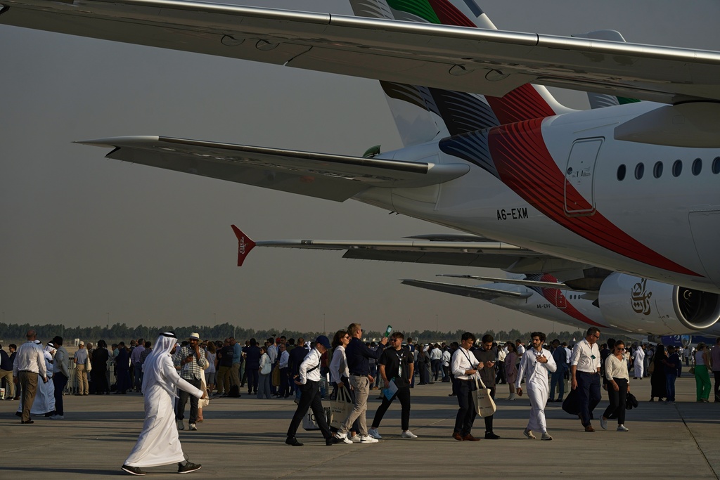 People walk at the Dubai Air Show in Dubai, United Arab Emirates, Tuesday, Nov. 18, 2025. (AP Photo/Fatima Shbair)