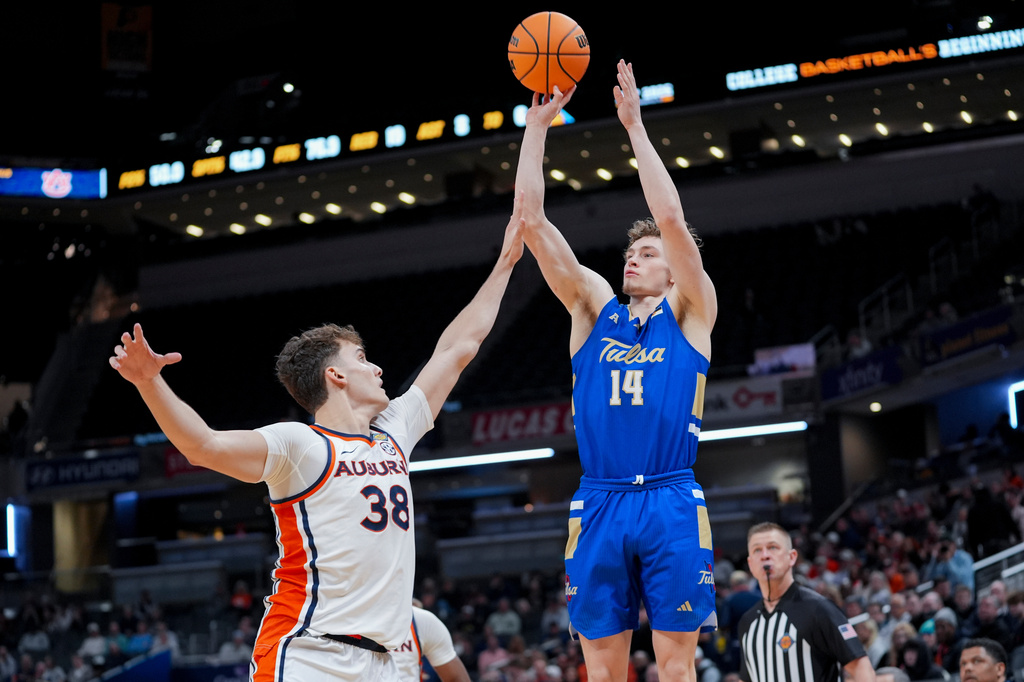 Tulsa guard Miles Barnstable (14) shoots over Auburn forward Filip Jovic (38) during the second half of the NCAA college basketball NIT Championship game, Sunday, April 5, 2026, in Indianapolis. (AP Photo/Abbie Parr)