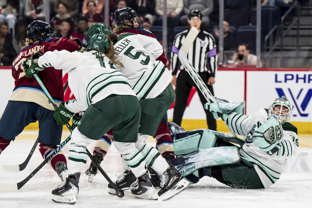 Boston Fleet goaltender Abbey Levy (39) is knocked down defending the net during the second period of an PWHL hockey game against the Montreal Victoire in Laval, Quebec, on Friday, April 17, 2026. (Christopher Katsarov/The Canadian Press via AP)