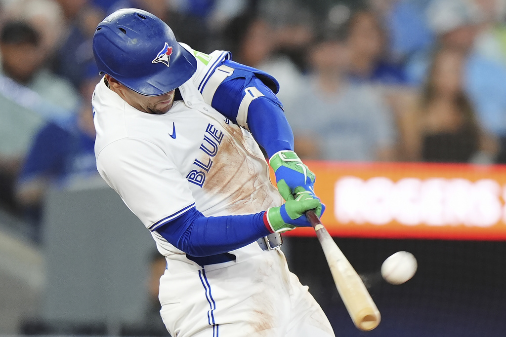 Toronto Blue Jays' George Springer hits a solo home run against the Minnesota Twins during the second inning of a baseball game in Toronto on Tuesday, Aug. 26, 2025. (Frank Gunn/The Canadian Press via AP)