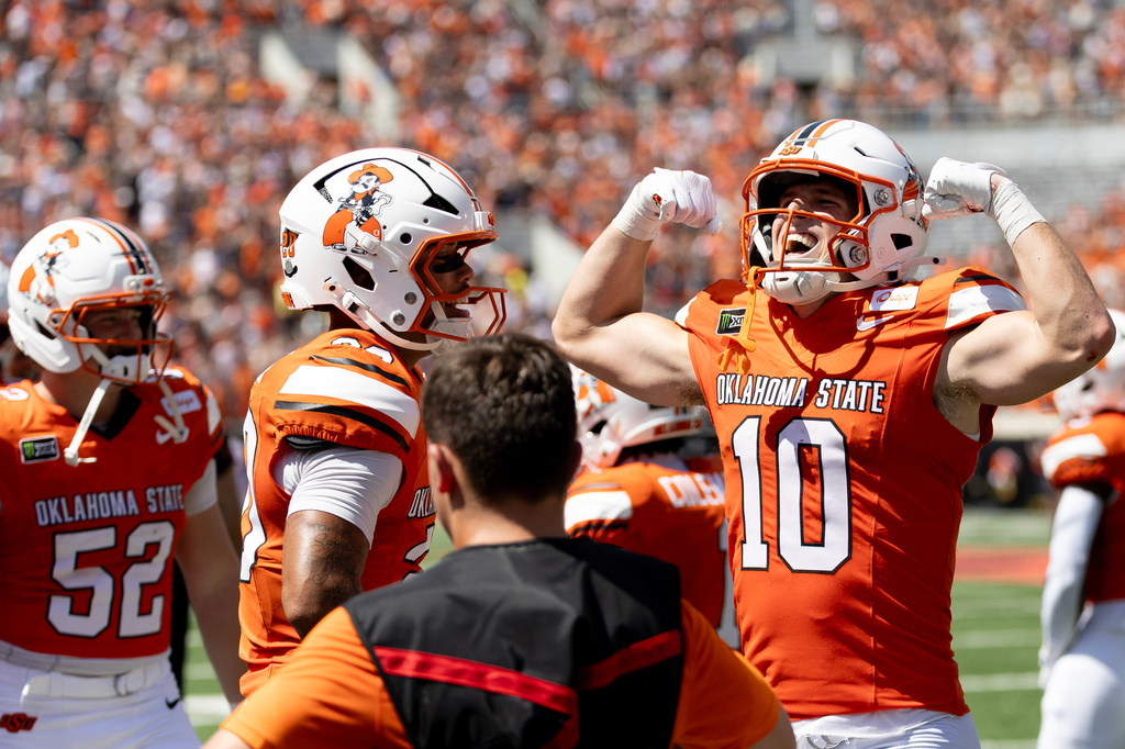 Oklahoma State wide receiver Wyatt Young (10) celebrates towards the fans after scoring a touchdown in the first half of the NCAA college football game against Oregon in Stillwater, Okla., Saturday, Sept. 12, 2026. (AP Photo/Mitch Alcala)