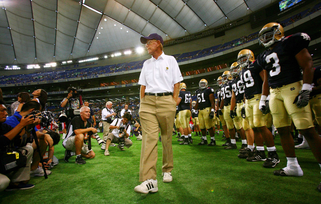 FILE - Notre Dame football coach Lou Holtz and his team players await before the start of their game against Japan's national American football team at the Notre Dame Japan Bowl in Tokyo, Saturday, July 25, 2009. (AP Photo/Junji Kurokawa, File)