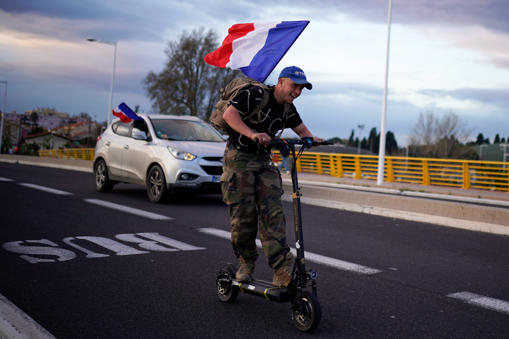 FILE - Supporters of French far-right leader Marine Le Pen leave after a campaign rally in Perpignan, southern France, Thursday, April 7, 2022. (AP Photo/Joan Mateu Parra, File)