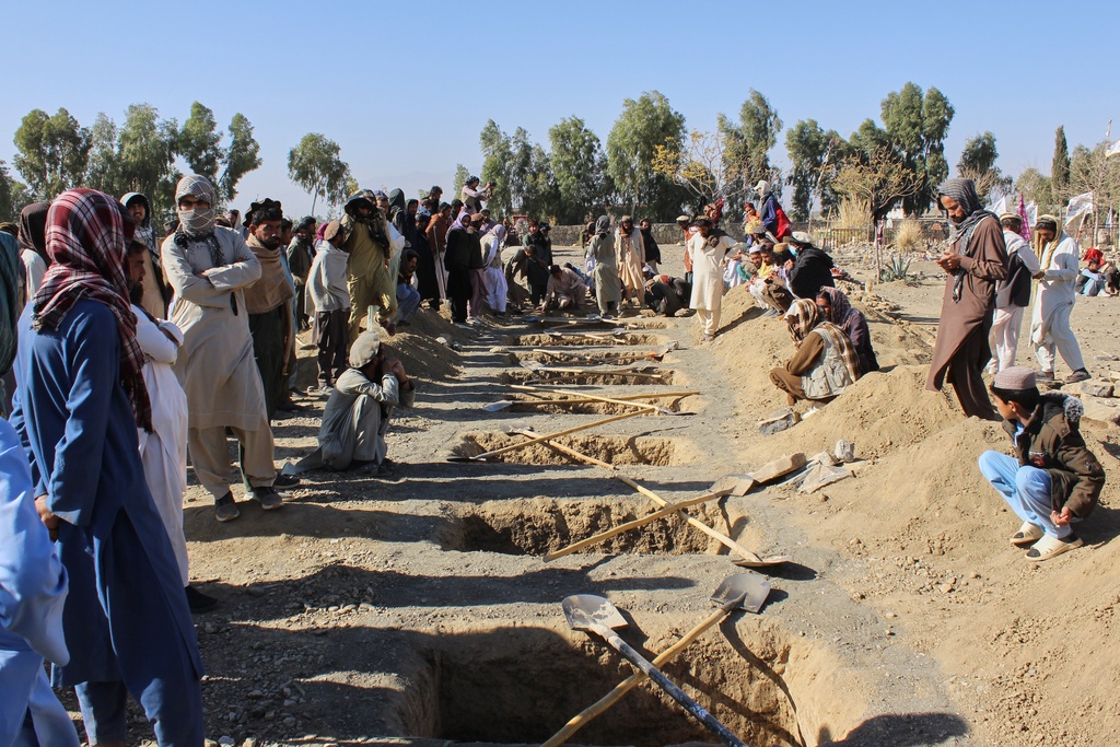 Locals prepare graves for victims of an overnight attack on a home that, according to an Afghan government spokesman, was carried out by Pakistan, in the Gurbaz district of Khost province, Afghanistan, Tuesday, Nov. 25, 2025. (AP Photo/Saifullah Zahir)