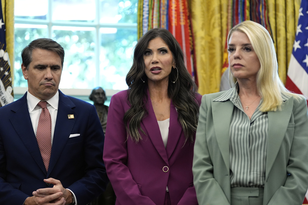 Homeland Security Secretary Kristi Noem, center, speaks as Deputy Attorney General Todd Blanche, left, and Attorney General Pam Bondi, right, listen during an event with President Donald Trump in the Oval Office of the White House, Monday, Sept. 15, 2025, in Washington. (AP Photo/Alex Brandon)