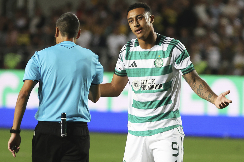 Celtic's Adam Idah, right, speaks with referee Maurizio Mariani during the Champions League playoff second leg soccer match between Kairat and Celtic at Ortalyk stadium in Almaty, Kazakhstan, Tuesday, Aug. 26, 2025. (AP Photo/Alikhan Sariyev)