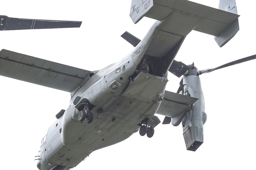 A soldier looks down from a military aircraft as the U.S. Embassy holds an emergency and air evacuation drill in Caracas, Venezuela, Saturday, May 23, 2026. (AP Photo/Pedro Mattey)