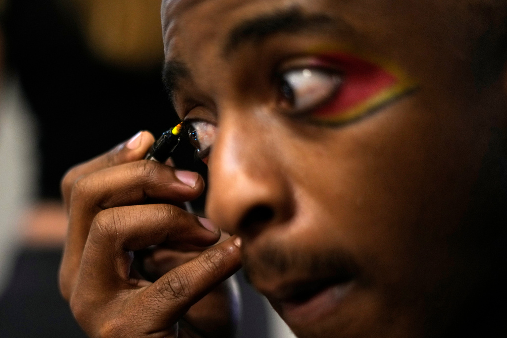Circus performer Brian Ngobese applies makeup as he prepares for his appearance in The Cirk’s “Worlds Away” show in Johannesburg, Friday, Aug. 28, 2026. (AP Photo/Themba Hadebe)