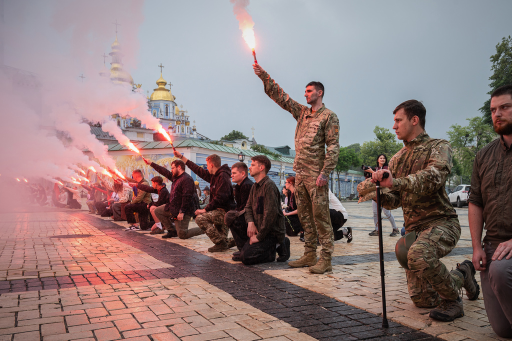 People light up flares during the funeral ceremony of fallen Ukrainian serviceman of 3rd assault brigade Yaroslav Ivanov in Kyiv, Ukraine, Monday, June 8, 2026. (AP Photo/Danylo Antoniuk)